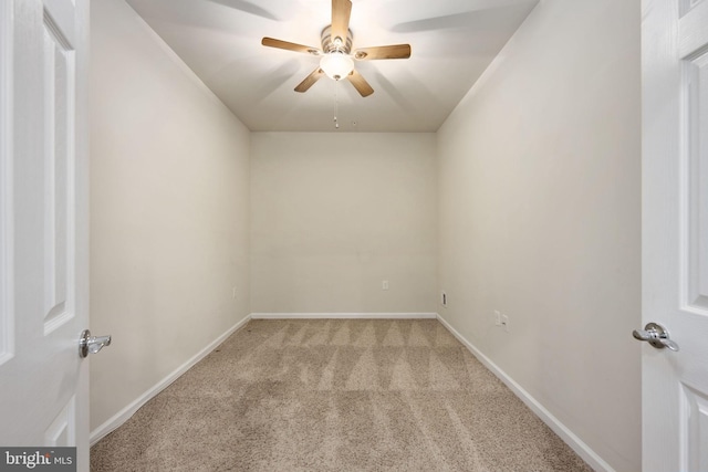 unfurnished room with light carpet, baseboards, and a ceiling fan