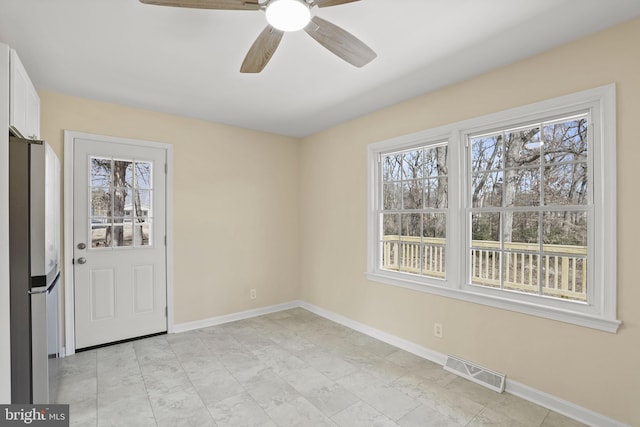 entrance foyer featuring visible vents, a ceiling fan, and baseboards