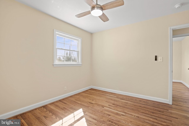 empty room featuring light wood-type flooring, baseboards, and ceiling fan