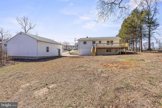 rear view of property featuring a wooden deck