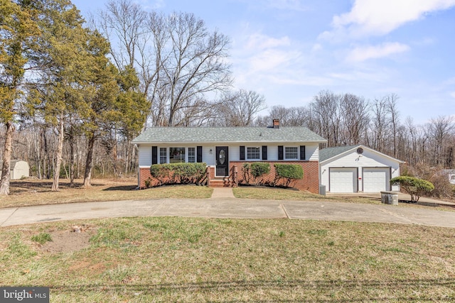 ranch-style home with a detached garage, brick siding, a chimney, and a front lawn