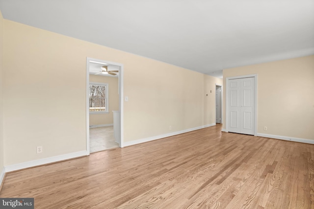 empty room with baseboards and light wood-style floors