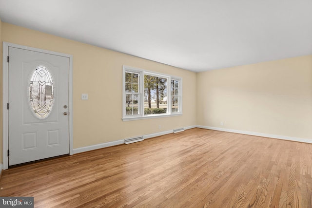 entrance foyer featuring light wood-style flooring, baseboards, and visible vents