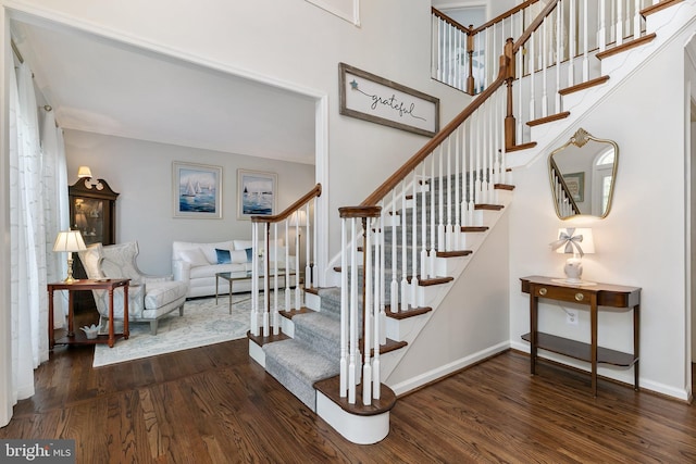 stairway featuring wood finished floors and baseboards