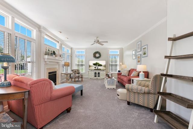 living area with ornamental molding, a high end fireplace, carpet floors, and ceiling fan