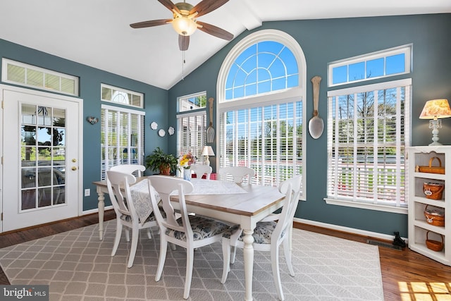 dining area with a wealth of natural light, wood finished floors, a ceiling fan, and vaulted ceiling