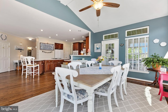 dining space featuring recessed lighting, light wood-style flooring, ceiling fan, baseboards, and lofted ceiling