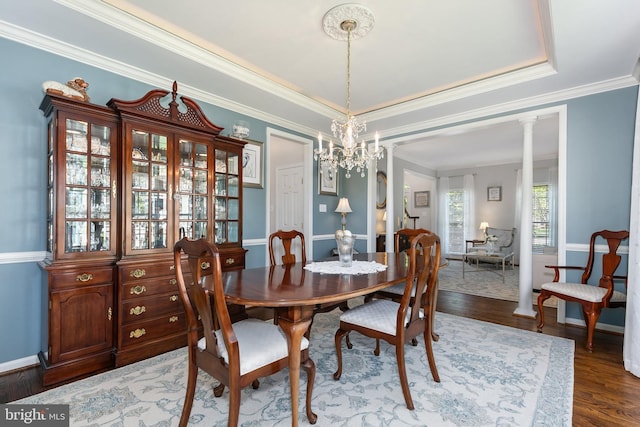 dining space with baseboards, dark wood-style flooring, and crown molding