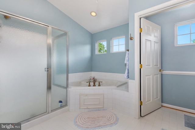 full bath featuring a garden tub, a stall shower, tile patterned flooring, and a healthy amount of sunlight