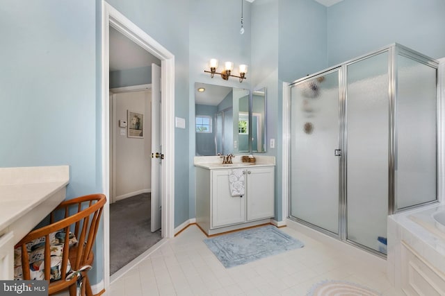 bathroom with a chandelier, a stall shower, baseboards, vanity, and tile patterned flooring
