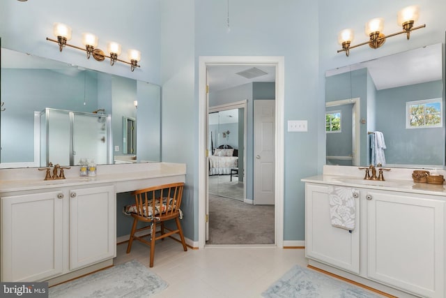 full bath with two vanities, a sink, a shower stall, and visible vents