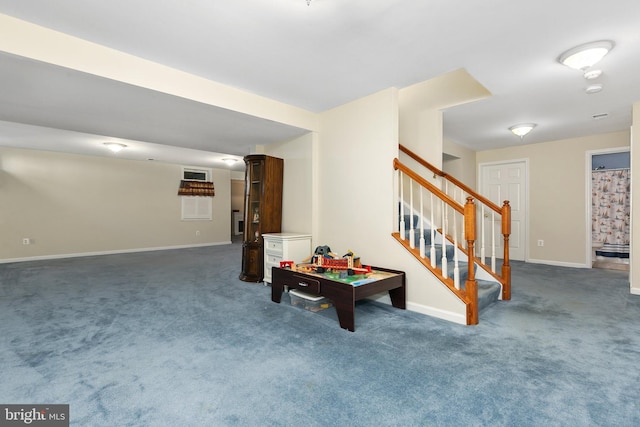 recreation room featuring carpet floors and baseboards