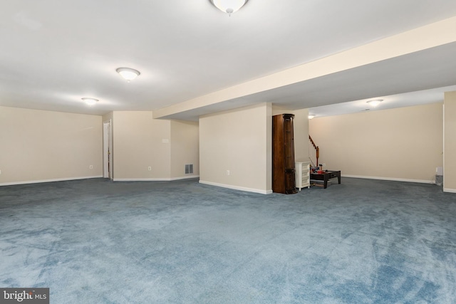 finished basement featuring baseboards, visible vents, and carpet flooring
