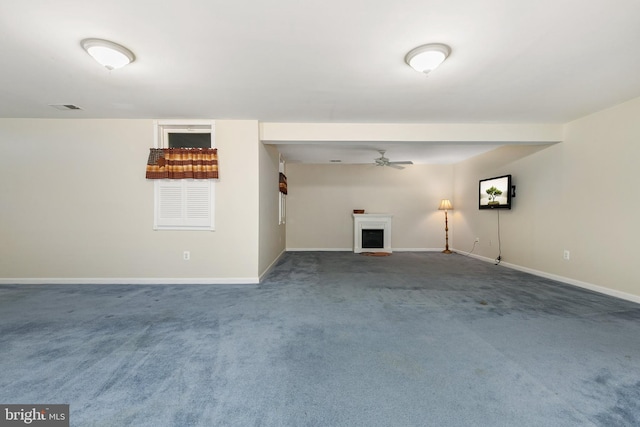 unfurnished living room with visible vents, a ceiling fan, carpet flooring, and baseboards