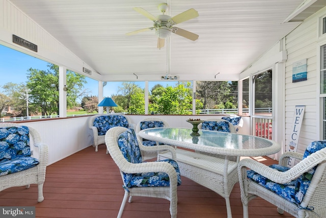 deck with outdoor dining area and a ceiling fan