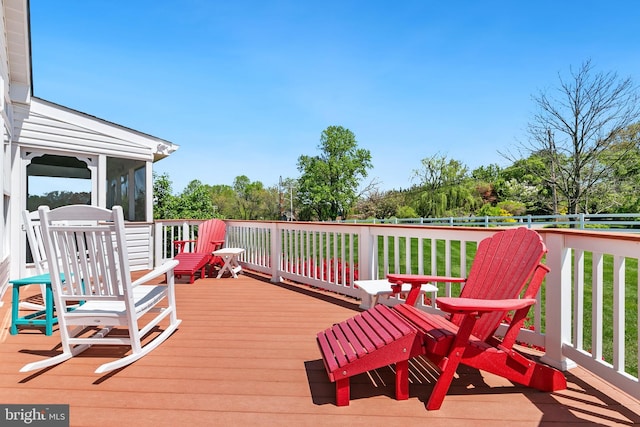 wooden deck with fence and a sunroom