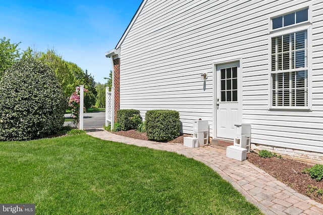 view of property exterior featuring a lawn