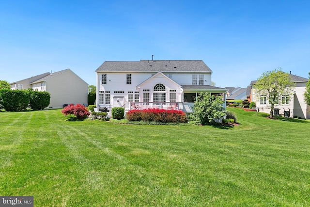 rear view of house with a lawn