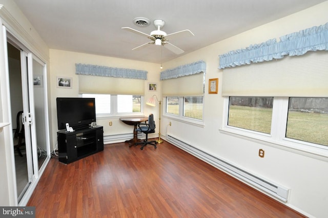 sunroom / solarium with a baseboard heating unit, a ceiling fan, visible vents, and baseboard heating