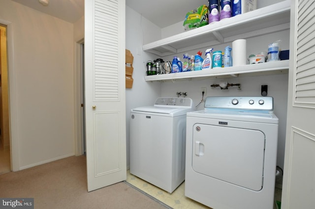 laundry area featuring washing machine and clothes dryer and laundry area