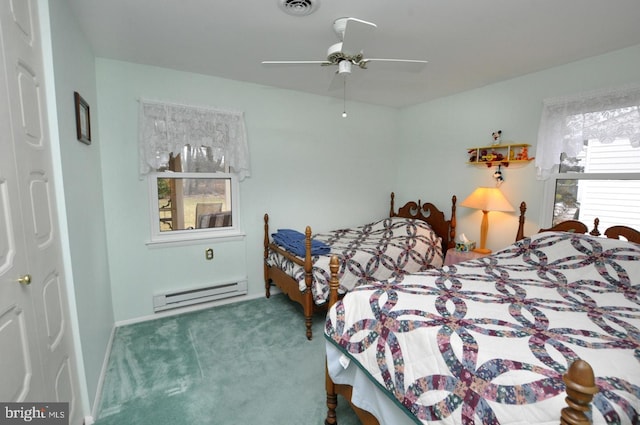 carpeted bedroom featuring visible vents, baseboard heating, and a ceiling fan