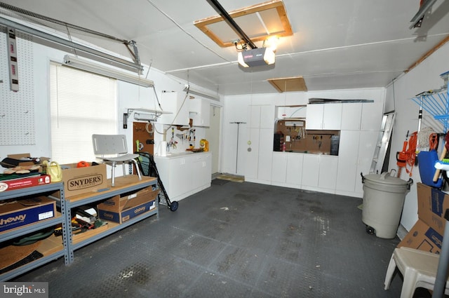 garage with a workshop area and a garage door opener