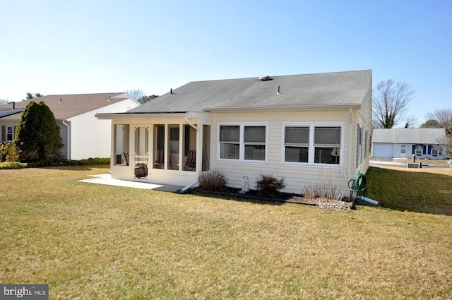 back of property featuring a yard and a sunroom