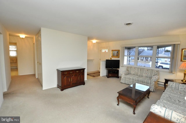 living area featuring visible vents, light colored carpet, and a baseboard radiator