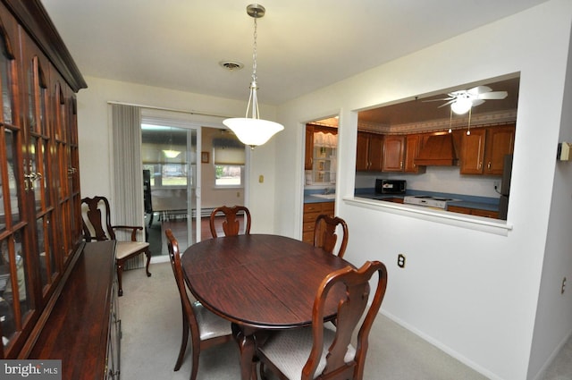 dining room featuring visible vents, light carpet, baseboards, and ceiling fan