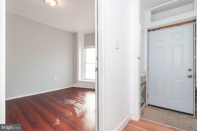 entrance foyer featuring baseboards and wood finished floors