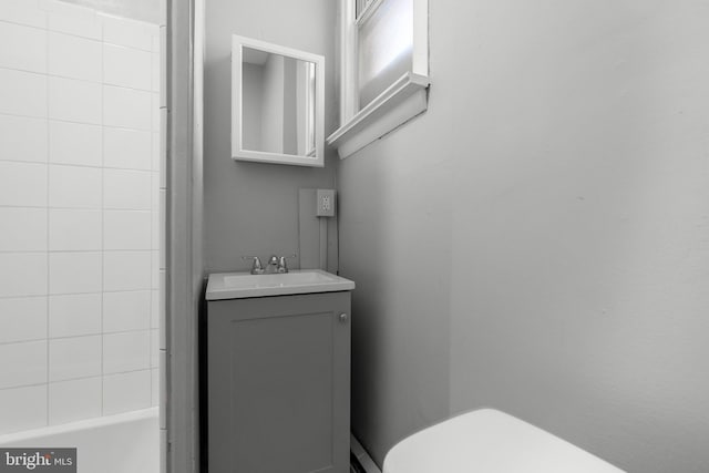 bathroom featuring toilet, a bathing tub, and vanity