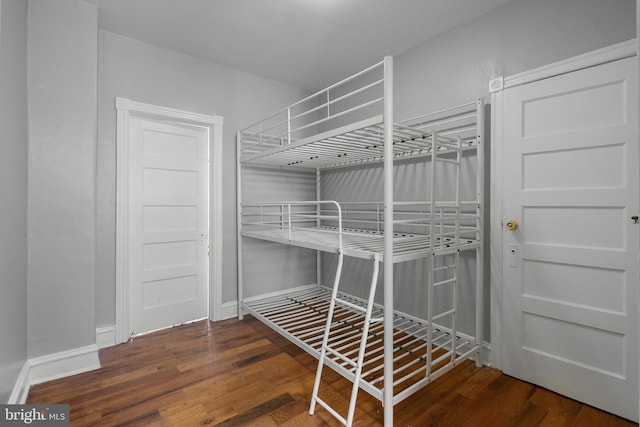 unfurnished bedroom featuring baseboards and wood finished floors