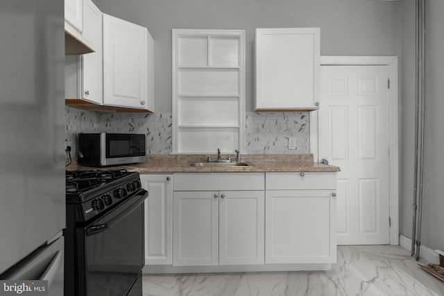 kitchen with stainless steel appliances, a sink, white cabinetry, marble finish floor, and tasteful backsplash