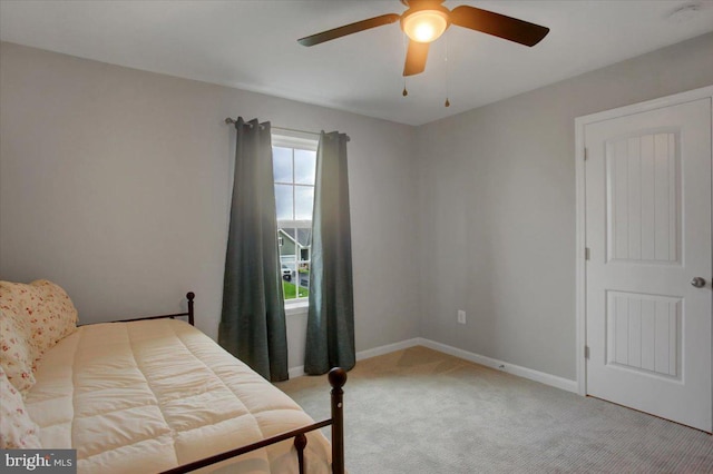 bedroom with carpet, a ceiling fan, and baseboards