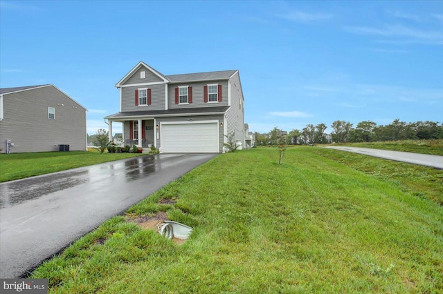 traditional home with an attached garage, aphalt driveway, and a front yard