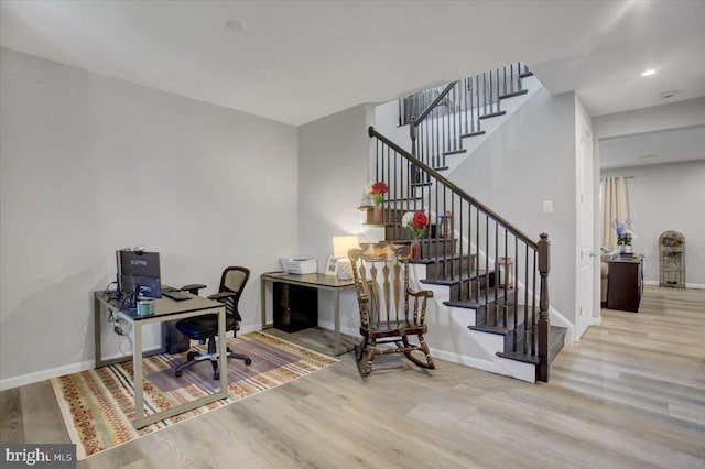 office space with wood finished floors and baseboards