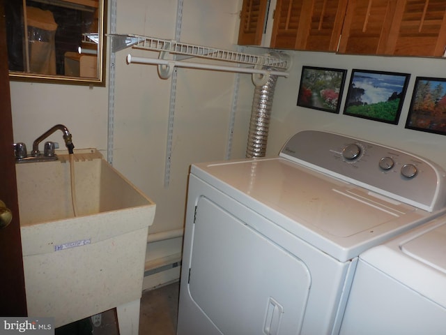 laundry room with washer and dryer and a sink