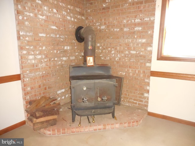 room details with a wood stove and baseboards