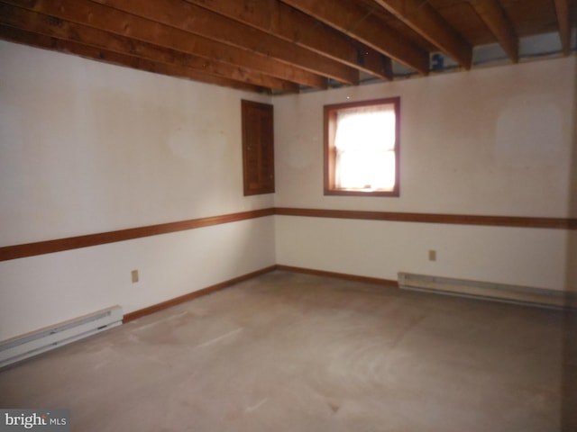 below grade area featuring a baseboard heating unit, carpet floors, and baseboards