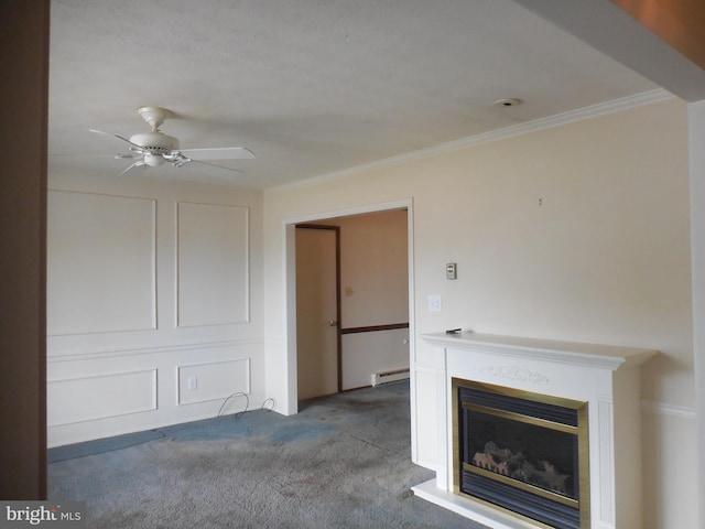 unfurnished living room featuring ceiling fan, ornamental molding, carpet flooring, and a glass covered fireplace