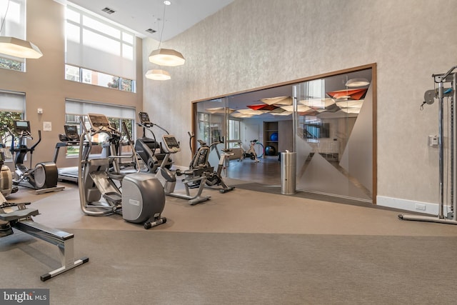 exercise room with a wealth of natural light and visible vents