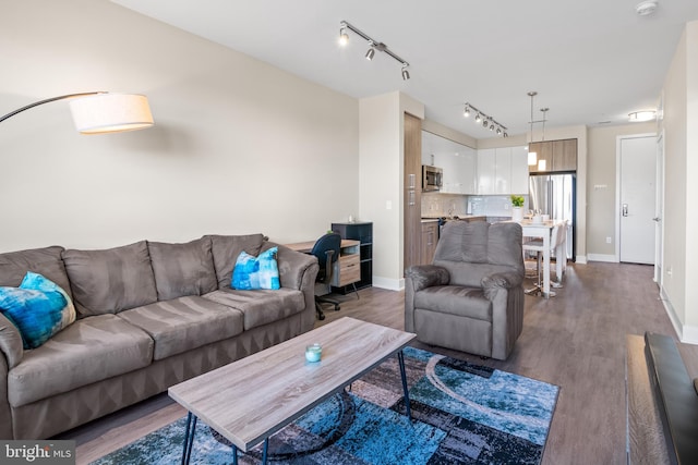 living area with dark wood-style floors and baseboards