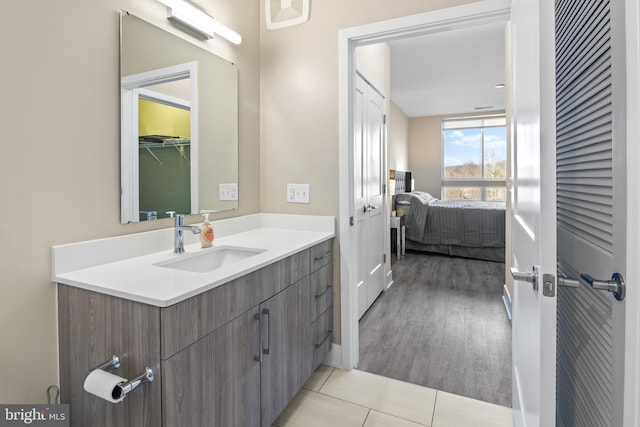 bathroom featuring connected bathroom, vanity, and tile patterned flooring