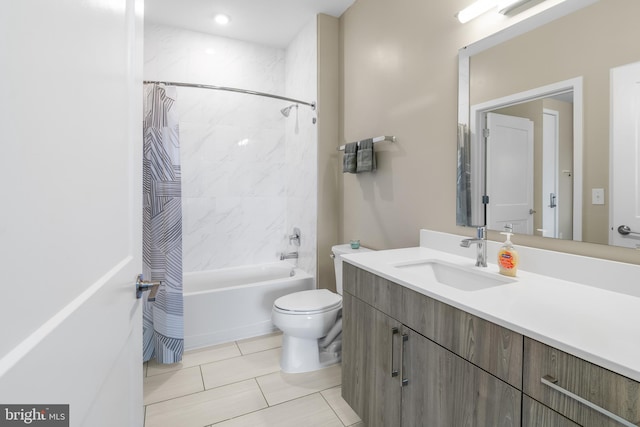 full bathroom featuring tile patterned floors, shower / bath combo with shower curtain, toilet, and vanity