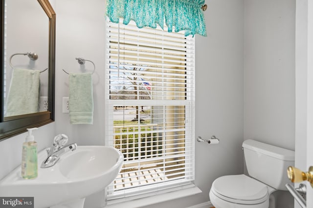 bathroom with toilet and a sink