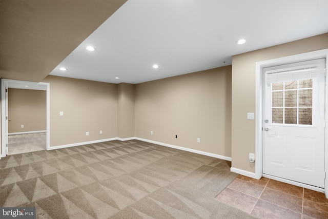 interior space featuring recessed lighting, light colored carpet, and baseboards