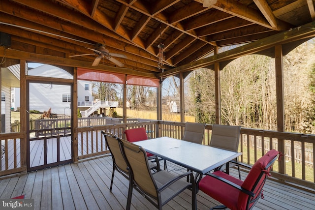 wooden terrace featuring outdoor dining area and a ceiling fan