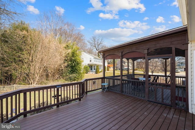 wooden deck featuring a lawn