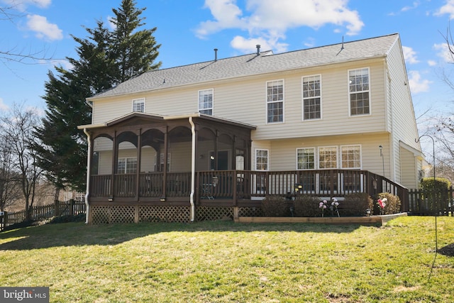 rear view of property with a yard and fence