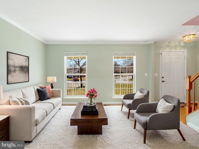 living area with stairway and crown molding